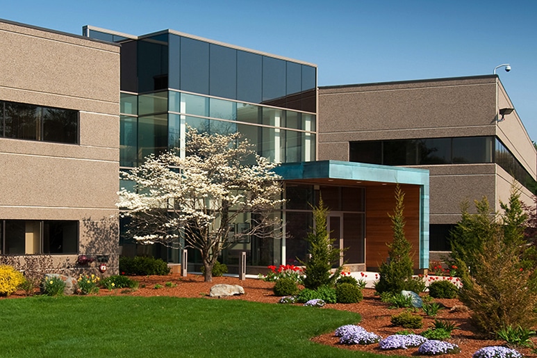 commercial building with flowering plants and trees with a plush lawn - commercial properties